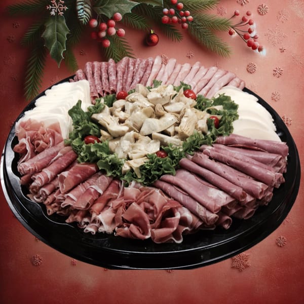 A festive holiday platter from Leona's Pizzeria with various meats, cheeses, artichokes, and cherry tomatoes.