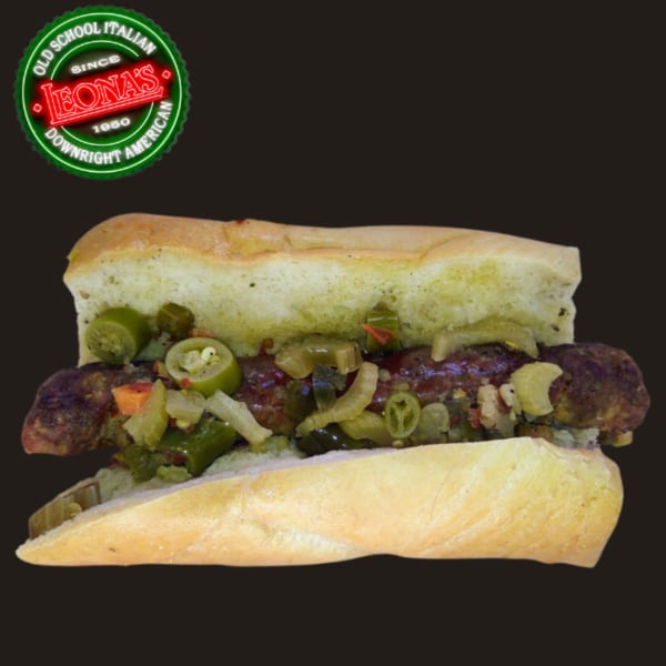 A Leona's Pizzeria sausage sandwich with peppers and onions on a dark background.