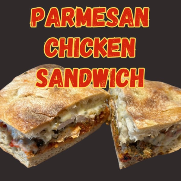 Leona's Pizzeria Parmesan Chicken Sandwich, cut in half, revealing melted cheese and chicken.