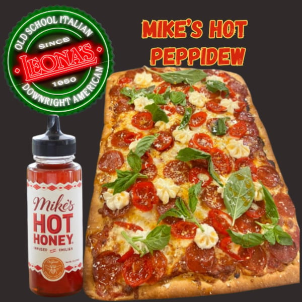 Leona's Pizzeria's Mike's Hot Peppidew pizza with pepperoni, tomatoes, basil, and a bottle of Mike's Hot Honey.