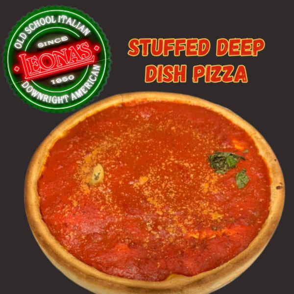 A Leona's Pizzeria stuffed deep dish pizza with rich red sauce, cheese, and basil.
