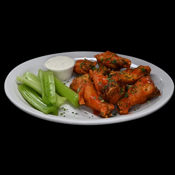 Leona's Pizzeria's buffalo wings with celery sticks and ranch dressing on a white plate.